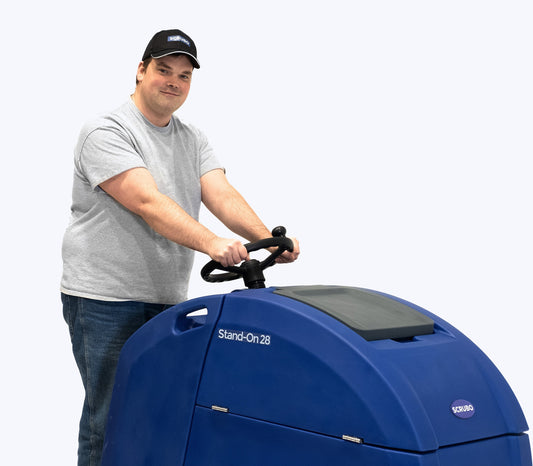 Extremely Handsome Man on a ride-on floor cleaner